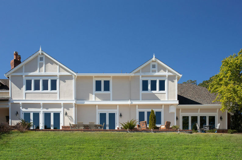 A modern two-story house with large windows and a spacious lawn, representing Alexander Company's architectural style in Burlingame.